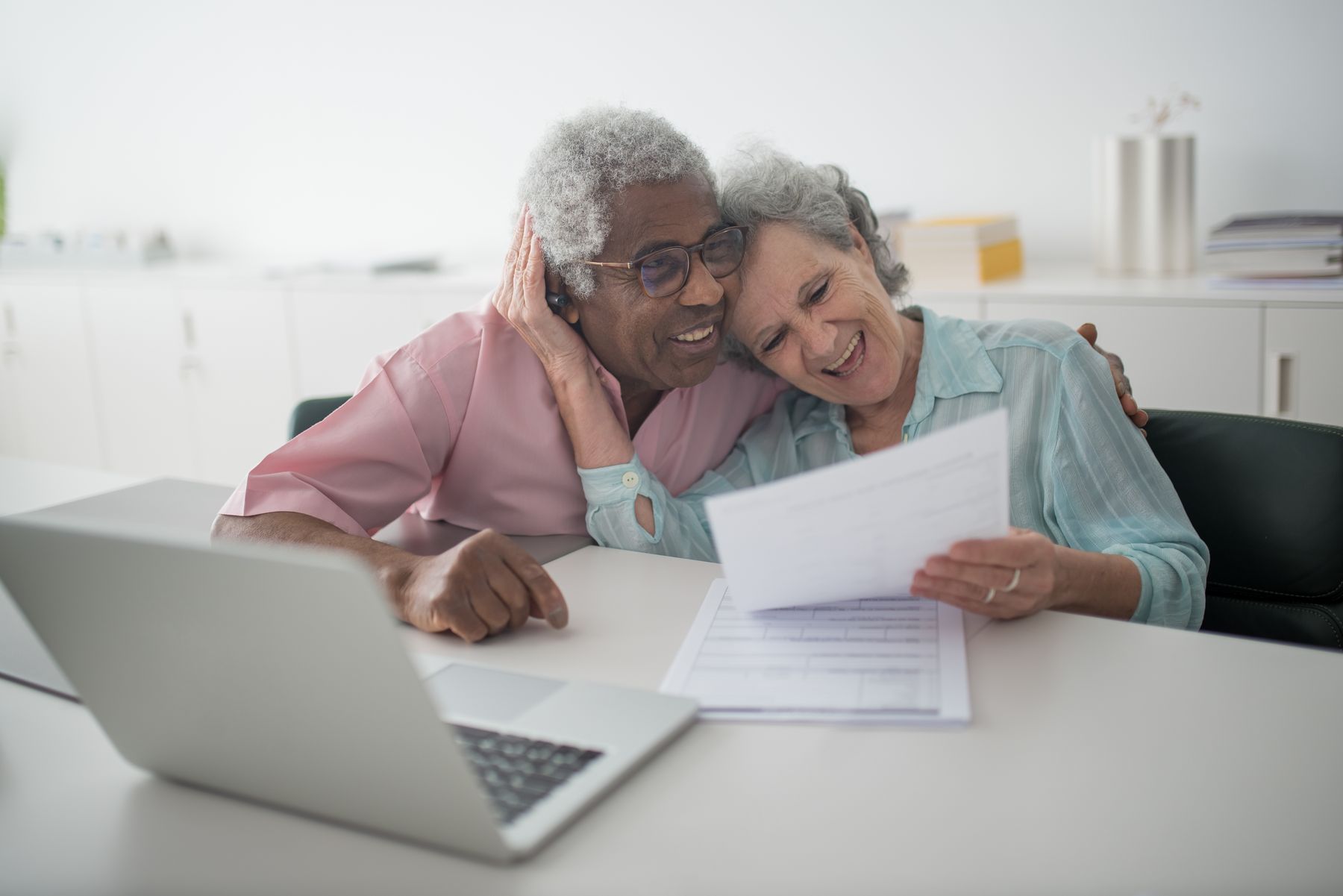 A retired couple reviewing a document together